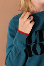 100% merino wool fine knit slogan jumper. Intarsia Ultra Violet slogan inspired by Andy Warhols superstars. Our retro colours pop and the super soft luxury knitwear supports slow sustainable fashion and independent brands.